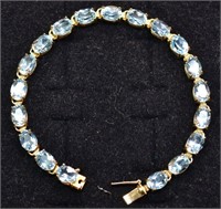 14kt gold and 19 oval blue stone tennis bracelet,
