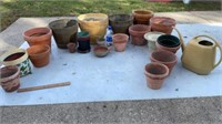 Assortment of clay and plastic plant pots,