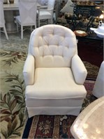 Two cream colored swivel side chairs