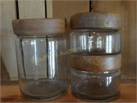 3 Glass Canisters w/wood lids tallest is 8"