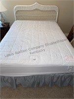 Queen sized whicker headboard bed.