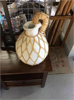 White decorative pottery jug with rattan wrapping