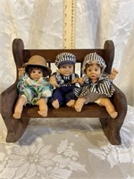 WOOD ROCKING BENCH AND 3 PORCELAIN BABIES