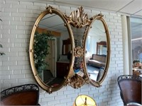 Curved Gold Toned Plastic Framed Mirror