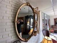 Curved Gold Toned Plastic Framed Mirror
