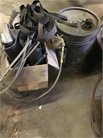 5 gallon bucket of oil with rope and tarps