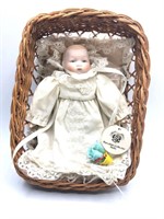 Small Porcelain Doll in a Basket
