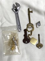 Keys, collectible pins and wrench