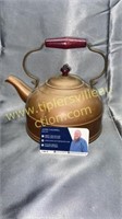 Copper kettle with red wood handle