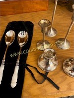 silver colored candle holders and serving