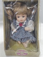 Sitting doll in box