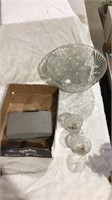 Polaroid camera, glass cups, glass bowl