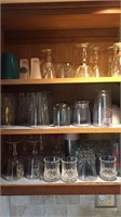 Three shelves of glassware, goblets