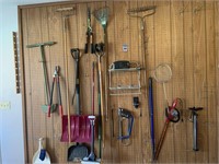 Entire pegboard wall of assorted garden tools,
