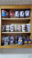 Cupboard of Pepsi drinking glasses (40+)