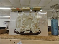white ceramic nativity with gold colored accents