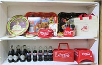 (2) Shelves of Coca Cola items including a cap,