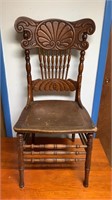 Antique pressed back oak side chair, with a solid