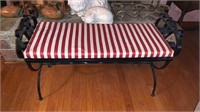 Black metal bench, with a red and white striped