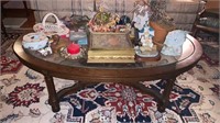 Oval glass top coffee table with the contents,