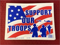 Large stack of support our troops signs