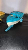 2 plastic Hubley Togo toy boats with trailers