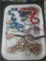 White tray of costume jewelry