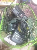 Green wire basket of cell phones and chords