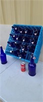 16 blue resealable bottles with plastic tray.