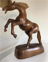 Carved wooden statue of rearing horse