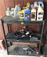 shelf and contents: jumper cables, oil,