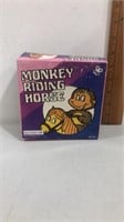 Monkey riding horse wind up tin toy in original