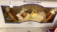Porcelain Indian doll on hammock in 22” long box