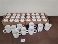 Flats of white glass mugs