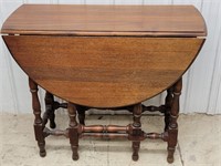 Swing leg drop leaf game table with a drawer top