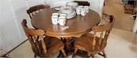 Dark wood pedestal table with 4 chairs and 1