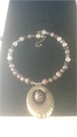 Necklace with beads and pendant with animal p