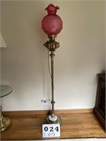 Ornate brass floor lamp with cranberry colored