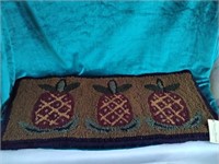 Hand hooked wool rug of pineapples