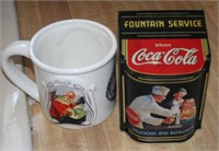 Coca-Cola mug and tin