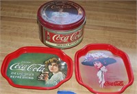 Coca-Cola trays and a tin