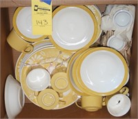 box of yellow dishes