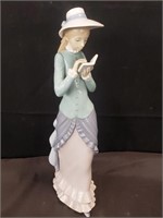 Lladro figurine of a woman reading a book