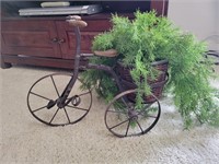 Metal bike plant holder with greenery