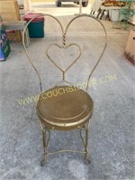 Brass colored metal heart back chair