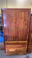 Vintage cedar clothing cabinet with a hanger