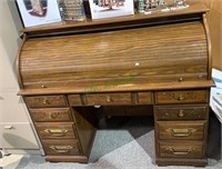 Large roll top desk with seven drawers below,
