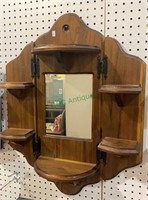 Vintage pine wood shelf unit with a mirror in the