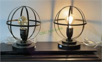 Pair of two table lamps with amber light bulbs.