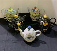 Group of 4 miniature tea pots with tea cups, one